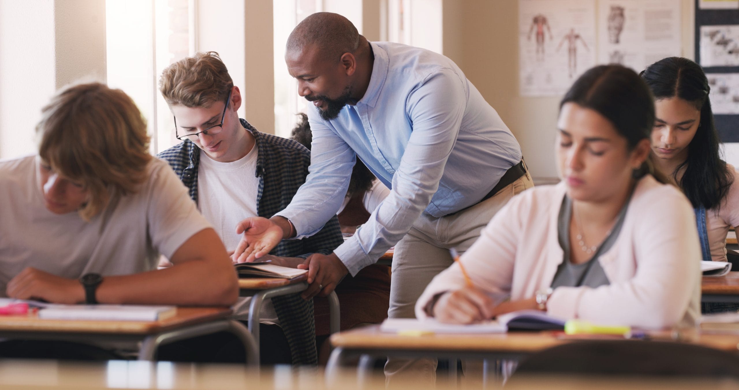 Teacher talking to student about assignment